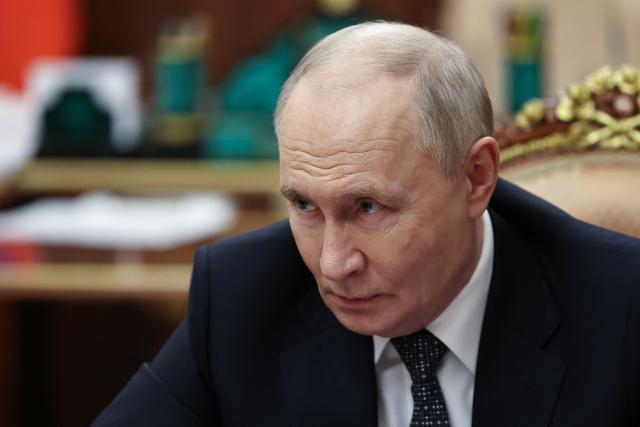 In this pool photograph distributed by the Russian state agency Sputnik, Russia's President Vladimir Putin meets with Moscow-installed leader of the Russian-controlled parts of the Zaporizhzhia region, at the Kremlin in Moscow on July 20, 2026. (Photo by Alexander KAZAKOV / POOL / AFP)