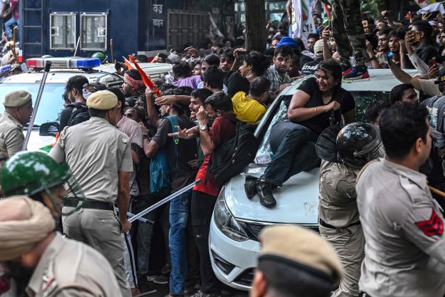 Police personnel baton-charge to disperse activists and supporters of the Cockroach Janta Party (CJP) during a protest demanding the resignation of India's Education Minister Dharmendra Pradhan over alleged NEET exam irregularities in New Delhi on July 20, 2026. Indian police fired tear gas and baton-charged protesters in New Delhi on July 20 as they tried to march on parliament to demand the resignation of the education minister over irregularities in major examinations. (Photo by Arun SANKAR / AFP)