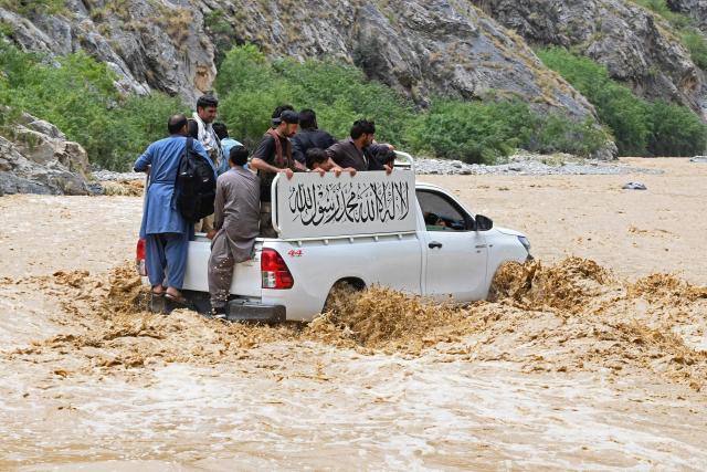 A police van wades through floodwater following heavy monsoon rains at Landi Kotal in Pakistan's Khyber Pakhtunkhwa province on July 20, 2026. (Photo by Abdul MAJEED / AFP)