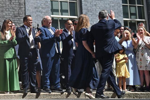 Britain's outgoing prime minister Keir Starmer and his wife Victoria walk down Downing Street after making a statement in front of 10 Downing Street in central London on July 20, 2026, before formally tendering his resignation to the king. (Photo by JUSTIN TALLIS / AFP)