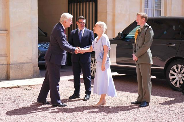Clive Alderton (L), Principal Private Secretary to the King greets Labour Party leader Andy Burnham and his wife Marie-France van Heel, as Burnham arrives for an audience at Buckingham Palace, London, where Britain's King Charles III invited the leader of the Labour Party to become Prime Minister and form a new government, on July 20, 2026 (Photo by Aaron Chown / POOL / AFP)