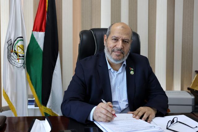(FILES) Khalil al-Hayya, senior leader and top Hamas legislative candidate, smiles during an interview with AFP at his office in Gaza City on April 21, 2021. Palestinian Islamist movement Hamas announced on July 20, 2026 that it had elected Khalil al-Hayya, the group's lead negotiator in indirect ceasefire talks with Israel, as the new head of its political bureau. (Photo by Emmanuel DUNAND / AFP)