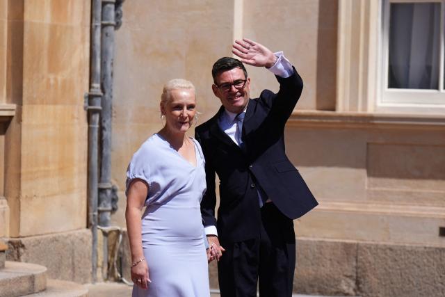 Labour Party leader Andy Burnham and his wife Marie-France van Heel, wave after an audience at Buckingham Palace, London, where Britain's King Charles III invited the leader of the Labour Party to become Prime Minister and form a new government, on July 20, 2026 (Photo by Aaron Chown / POOL / AFP)