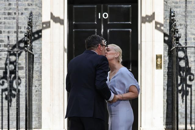 Britain's new Prime Minister Andy Burnham kisses his wife Marie-France van Heel on the steps of 10 Downing Street in central London on July 20, 2026, after being asked by the king to form the next government. (Photo by Henry NICHOLLS / AFP)