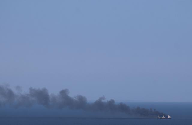 This photograph shows smoke rising from a civilian ship on the Black Sea off the coast of Odesa on July 19, 2026, amid the Russian invasion of Ukraine. (Photo by AFP)