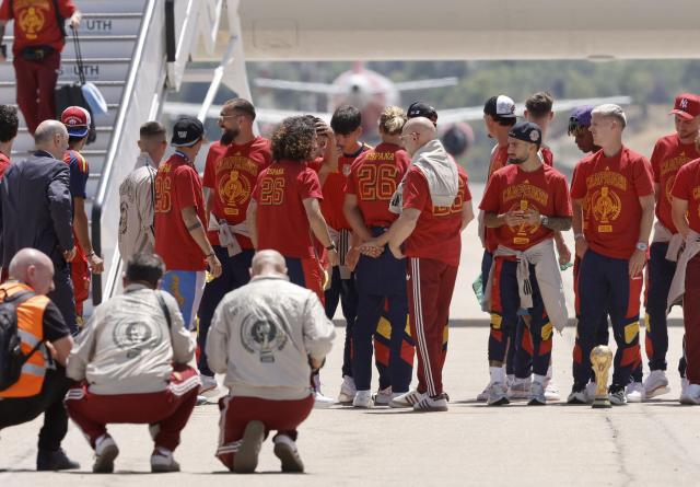 Spain's players stand on the tarmac upon their arrival from the US after winning the 2026 World Cup, in Madrid Barajas' airport, on July 20, 2026. Spain's World Cup winners come back home to a heroes' welcome in Madrid, where a million fans are expected to greet them after a night of raucous celebrations across the country. (Photo by Oscar DEL POZO / AFP)