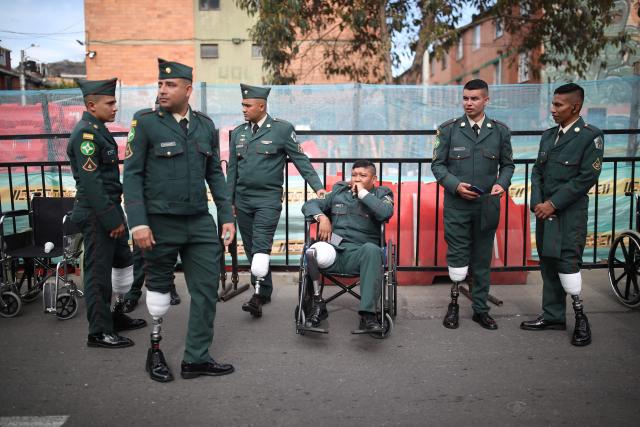 Military members with prosthetic legs wait to take part in a military parade commemorating Colombia's Independence Day in Bogota, on July 20, 2026. (Photo by ESTEBAN VEGA LA-ROTTA / AFP)