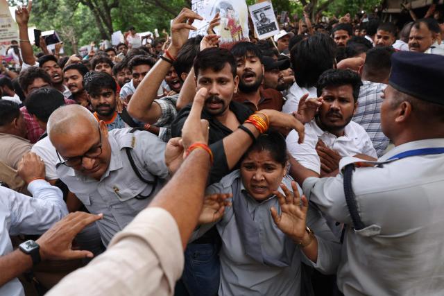 Banaras Hindu University (BHU) students in solidarity with Cockroach Janta Party (CJP) clash with security personnel during a protest demanding the resignation of India's Education Minister Dharmendra Pradhan over alleged NEET exam irregularities in Varanasi on July 20, 2026. Indian police fired tear gas and baton-charged protesters in New Delhi on July 20, as they tried to march on parliament to demand the resignation of the education minister over irregularities in major examinations. (Photo by Niharika KULKARNI / AFP)