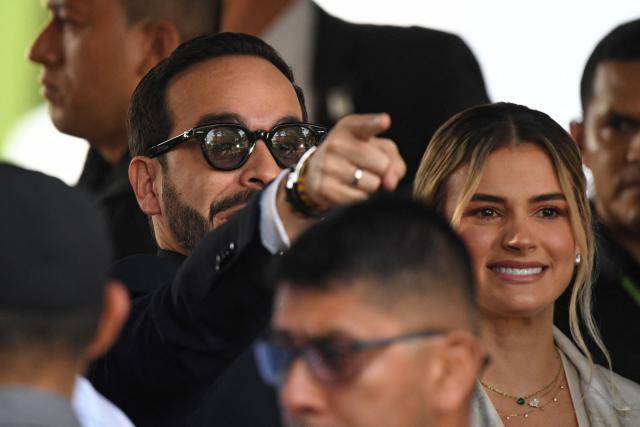Colombia's president-elect Abelardo de la Espriella points to the front next to his wife Ana Lucia Pineda as they attend a military parade commemorating Colombia's Independence Day in Medellin, Colombia, on July 20, 2026. (Photo by Jaime SALDARRIAGA / AFP)