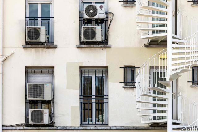 This photograph shows condensers of air conditioning units outside flats in Paris on July 20, 2026. (Photo by JOEL SAGET / AFP)