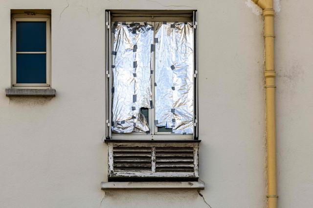This photograph shows a window sealed with a survival blanket to keep the heat out in Paris on July 20, 2026. (Photo by JOEL SAGET / AFP)