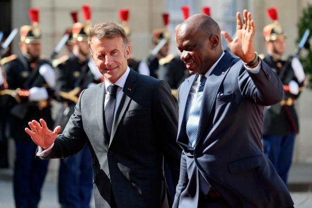 Gabon's President Brice Oligui Nguema (R) is welcomed by France's President Emmanuel Macron before a meeting at the Elysee Palace in Paris on July 20, 2026. (Photo by Ludovic MARIN / AFP)