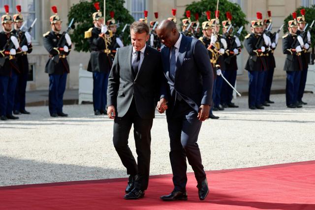 Gabon's President Brice Oligui Nguema (R) is welcomed by France's President Emmanuel Macron before a meeting at the Elysee Palace in Paris on July 20, 2026. (Photo by Ludovic MARIN / AFP)