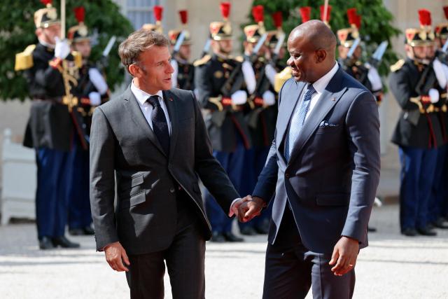 Gabon's President Brice Oligui Nguema (R) is welcomed by France's President Emmanuel Macron before a meeting at the Elysee Palace in Paris on July 20, 2026. (Photo by Ludovic MARIN / AFP)