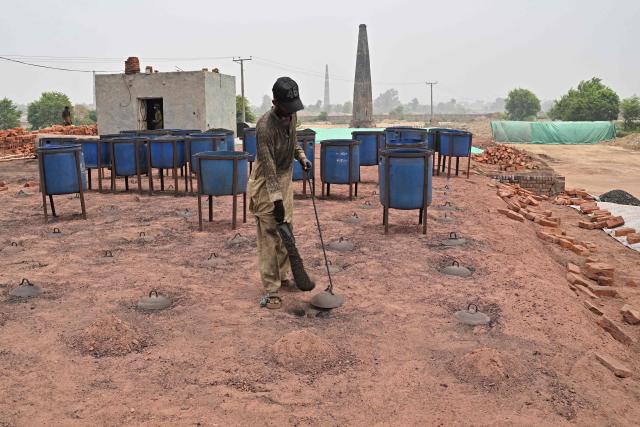 A man works at a brick kiln in Sheikhupura, in Pakistan’s Punjab province on July 20, 2026. (Photo by Arif ALI / AFP)