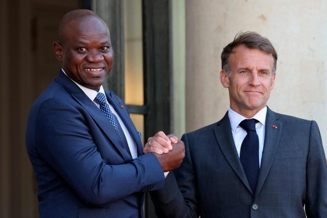 Gabon's President Brice Oligui Nguema (L) is welcomed by France's President Emmanuel Macron before a meeting at the Elysee Palace in Paris on July 20, 2026. (Photo by Ludovic MARIN / AFP)