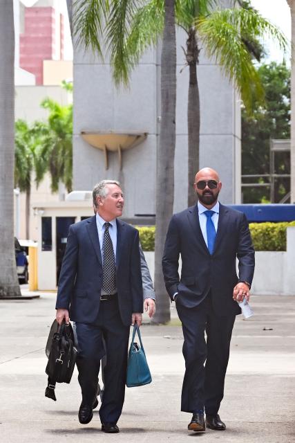 Joseph D. McBride (R), attorney for Andrew Tate and Tristan Tate, arrives ahead of the hearing for the Tate brothers at the C. Clyde Atkins US Courthouse in Miami, Florida, on July 20, 2026. Radical social media influencer Andrew Tate and his brother Tristan were in custody in the US on July 19,  officials said, as Britain seeks their extradition to face new charges of rape, sex trafficking and assault. (Photo by CHANDAN KHANNA / AFP)