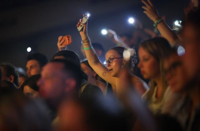 The audience hold their phones aloft during the first day of the Francofolies de Spa music festival in Spa on July 20, 2026. (Photo by VIRGINIE LEFOUR / Belga / AFP) / Belgium OUT