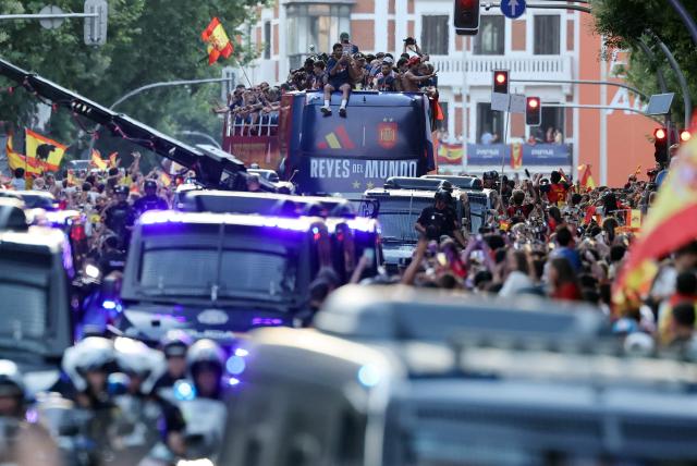 Spain's players parade onboard an open-top bus through the streets of Madrid on July 20, 2026, one day after the national football team won their second World Cup title following a 1-0 victory against Argentina. Spain's World Cup winners come back home to a heroes' welcome in Madrid, where a million fans are expected to greet them after a night of raucous celebrations across the country. (Photo by Thomas COEX / AFP)