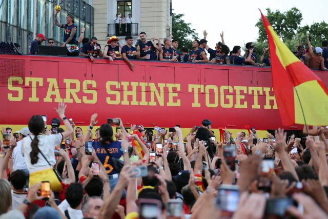 Spain's players parade onboard an open-top bus through the streets of Madrid on July 20, 2026, one day after the national football team won their second World Cup title following a 1-0 victory against Argentina. Spain's World Cup winners come back home to a heroes' welcome in Madrid, where a million fans are expected to greet them after a night of raucous celebrations across the country. (Photo by Thomas COEX / AFP)