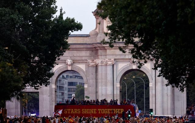 Spain's players parade onboard an open-top bus through the streets of Madrid on July 20, 2026, one day after the national football team won their second World Cup title following a 1-0 victory against Argentina. Spain's World Cup winners come back home to a heroes' welcome in Madrid, where a million fans are expected to greet them after a night of raucous celebrations across the country. (Photo by Oscar DEL POZO / AFP)