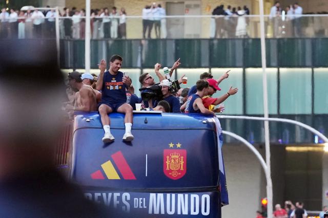 Spain's players parade onboard an open-top bus through the streets of Madrid on July 20, 2026, one day after the national football team won their second World Cup title following a 1-0 victory against Argentina. Spain's World Cup winners come back home to a heroes' welcome in Madrid, where a million fans are expected to greet them after a night of raucous celebrations across the country. (Photo by Cesar MANSO / AFP)