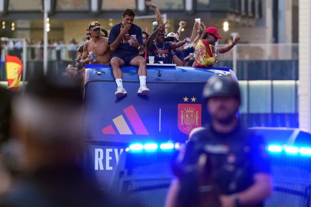 Spain's players parade onboard an open-top bus through the streets of Madrid on July 20, 2026, one day after the national football team won their second World Cup title following a 1-0 victory against Argentina. Spain's World Cup winners come back home to a heroes' welcome in Madrid, where a million fans are expected to greet them after a night of raucous celebrations across the country. (Photo by Cesar MANSO / AFP)