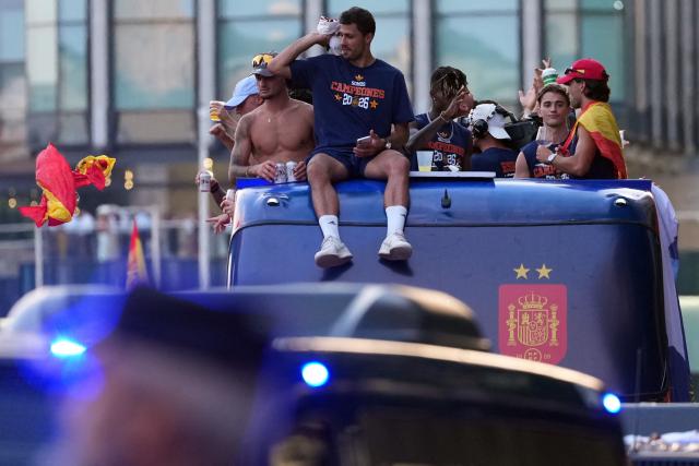 Spain's players parade onboard an open-top bus through the streets of Madrid on July 20, 2026, one day after the national football team won their second World Cup title following a 1-0 victory against Argentina. Spain's World Cup winners come back home to a heroes' welcome in Madrid, where a million fans are expected to greet them after a night of raucous celebrations across the country. (Photo by Cesar MANSO / AFP)