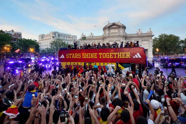 Spain's players parade onboard an open-top bus through the streets of Madrid on July 20, 2026, one day after the national football team won their second World Cup title following a 1-0 victory against Argentina. Spain's World Cup winners come back home to a heroes' welcome in Madrid, where a million fans are expected to greet them after a night of raucous celebrations across the country. (Photo by Paul Hanna / AFP)