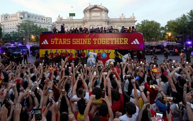 Spain's players parade onboard an open-top bus through the streets of Madrid on July 20, 2026, one day after the national football team won their second World Cup title following a 1-0 victory against Argentina. Spain's World Cup winners come back home to a heroes' welcome in Madrid, where a million fans are expected to greet them after a night of raucous celebrations across the country. (Photo by Paul Hanna / AFP)