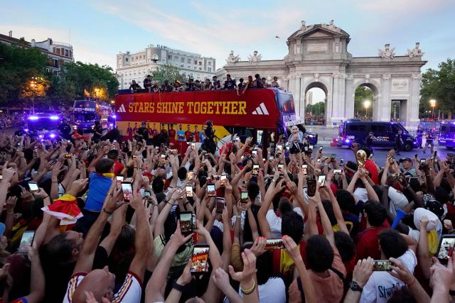 Spain's players parade onboard an open-top bus through the streets of Madrid on July 20, 2026, one day after the national football team won their second World Cup title following a 1-0 victory against Argentina. Spain's World Cup winners come back home to a heroes' welcome in Madrid, where a million fans are expected to greet them after a night of raucous celebrations across the country. (Photo by Paul Hanna / AFP)