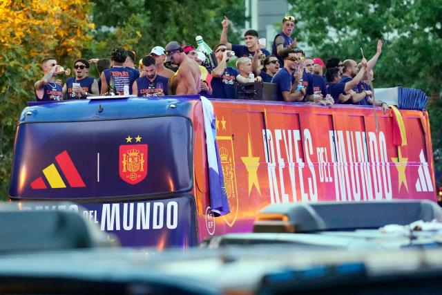 Spain's players parade onboard an open-top bus through the streets of Madrid on July 20, 2026, one day after the national football team won their second World Cup title following a 1-0 victory against Argentina. Spain's World Cup winners come back home to a heroes' welcome in Madrid, where a million fans are expected to greet them after a night of raucous celebrations across the country. (Photo by Paul Hanna / AFP)