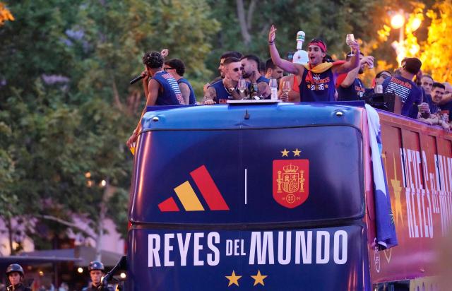 Spain's forward Ferran Torres (R) and teammates parade onboard an open-top bus through the streets of Madrid on July 20, 2026, one day after the national football team won their second World Cup title following a 1-0 victory against Argentina. Spain's World Cup winners come back home to a heroes' welcome in Madrid, where a million fans are expected to greet them after a night of raucous celebrations across the country. (Photo by Paul Hanna / AFP)