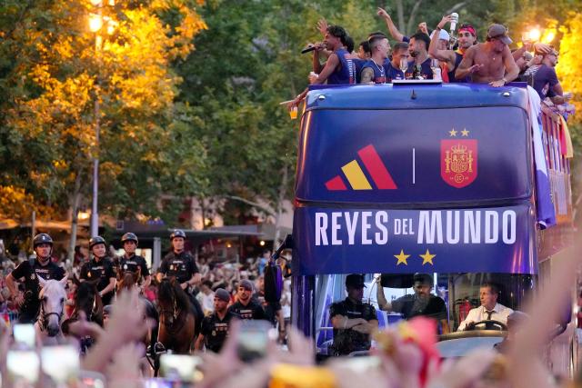 Spain's forward Lamine Yamal (TOP L) and teammates parade onboard an open-top bus through the streets of Madrid on July 20, 2026, one day after the national football team won their second World Cup title following a 1-0 victory against Argentina. Spain's World Cup winners come back home to a heroes' welcome in Madrid, where a million fans are expected to greet them after a night of raucous celebrations across the country. (Photo by Paul Hanna / AFP)