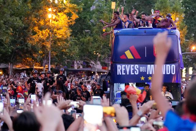 Spain's forward Lamine Yamal (TOP L) and teammates parade onboard an open-top bus through the streets of Madrid on July 20, 2026, one day after the national football team won their second World Cup title following a 1-0 victory against Argentina. Spain's World Cup winners come back home to a heroes' welcome in Madrid, where a million fans are expected to greet them after a night of raucous celebrations across the country. (Photo by Paul Hanna / AFP)