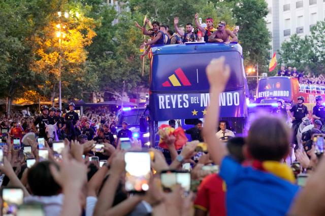 Spain's players parade onboard an open-top bus through the streets of Madrid on July 20, 2026, one day after the national football team won their second World Cup title following a 1-0 victory against Argentina. Spain's World Cup winners come back home to a heroes' welcome in Madrid, where a million fans are expected to greet them after a night of raucous celebrations across the country. (Photo by Paul Hanna / AFP)