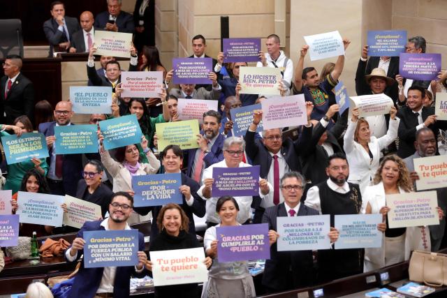 Lawmakers hold placards with messages praising Colombian President Gustavo Petro and his government during the installation of the ordinary sessions of Congress in Bogota on July 20, 2026. (Photo by ESTEBAN VEGA LA-ROTTA / AFP)