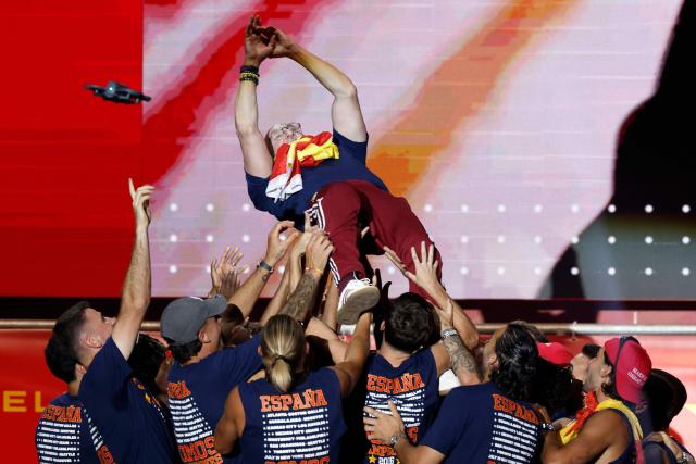 Spain's coach Luis de la Fuente is tossed by players as they celebrate on a stage at Cibeles Square in Madrid on July 20, 2026, one day after winning their second World Cup title following a 1-0 victory against Argentina. Spain's World Cup winners come back home to a heroes' welcome in Madrid, where a million fans are expected to greet them after a night of raucous celebrations across the country. (Photo by Oscar DEL POZO / AFP)