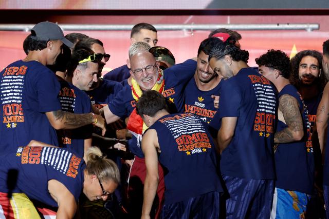 Spain's coach Luis de la Fuente (C) smiles after being tossed by players as they celebrate on a stage at Cibeles Square in Madrid on July 20, 2026, one day after winning their second World Cup title following a 1-0 victory against Argentina. Spain's World Cup winners come back home to a heroes' welcome in Madrid, where a million fans are expected to greet them after a night of raucous celebrations across the country. (Photo by Oscar DEL POZO / AFP)