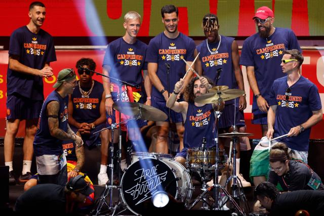 Spain's defender Marc Cucurella plays the drums as Spain's players celebrate on a stage at Cibeles Square in Madrid on July 20, 2026, one day after winning their second World Cup title following a 1-0 victory against Argentina. Spain's World Cup winners come back home to a heroes' welcome in Madrid, where a million fans are expected to greet them after a night of raucous celebrations across the country. (Photo by Oscar DEL POZO / AFP)