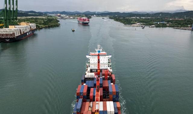 (FILES) This aerial view shows two cargo ships sailing out of the Panama Canal on the Pacific side in Panama City on October 6, 2025. The Panamanian government announced on July 20, 2026, an agreement with China to renew a treaty that grants the Panamanian fleet preferential treatment in Chinese ports. (Photo by MARTIN BERNETTI / AFP)