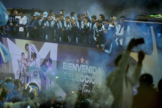 Argentina's national football team rides aboard an open-top bus towards the Argentine Football Association (AFA) training camp in Ezeiza, Buenos Aires Province, on July 20, 2026, after returning from the United States following its defeat in the 2026 FIFA World Cup final. (Photo by TOMAS CUESTA / AFP)