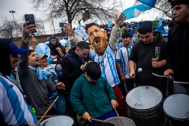 A fan wears a mask depicting Argentina's forward Lionel Messi close to the Argentine Football Association (AFA) training camp in Ezeiza, Buenos Aires Province, on July 20, 2026, while waiting for the arrival of Argentina's national football team from the United States following its defeat in the 2026 FIFA World Cup final. (Photo by TOMAS CUESTA / AFP)