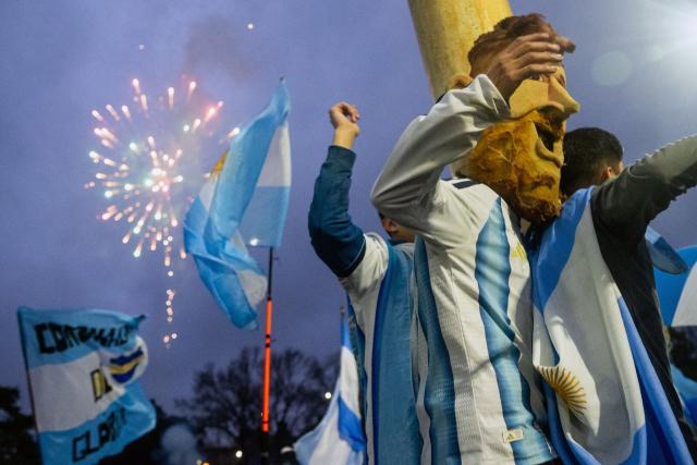 A fan wears a mask depicting Argentina's forward Lionel Messi while waiting for the arrival of Argentina's national football team from the United States following their defeat in the 2026 FIFA World Cup final, near the Argentine Football Association (AFA) training camp in Ezeiza, Buenos Aires Province, on July 20, 2026. (Photo by TOMAS CUESTA / AFP)