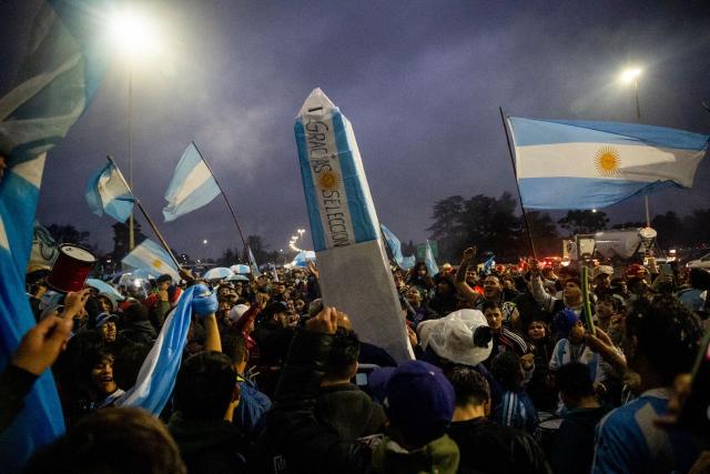 Fans wave Argentine flags as they gather outside the Argentine Football Association (AFA) training camp in Ezeiza, Buenos Aires Province, on July 20, 2026, while waiting for the arrival of Argentina's national football team from the United States following their defeat in the 2026 FIFA World Cup final. (Photo by TOMAS CUESTA / AFP)