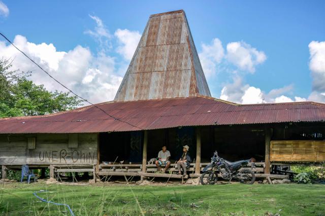 This photo taken on June 23, 2026 shows a traditional Sumba house with its tall central roof at Tanggedu village in East Sumba, East Nusa Tenggara. Two hours from the tourist beaches of Bali, slavery is alive and well on the Indonesian island of Sumba, where people are still being born into bondage. Eight of out 10 of Sumba's population of 685,000 people are Christian but its older "marapu" belief system, that blends animism and ancestor worship, has deep roots. It divides society into three castes, "the nobles, called 'maramba' -- often large landowners -- ordinary people called 'kabihu' and the slaves/servants, the atas," said rights activist Martha Hebi, author of several studies on the subject. (Photo by BAY ISMOYO / AFP) / To go with Indonesia-Sumba-slavery, SPECIAL REPORT by Eric Bernaudeau