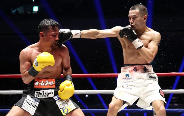 Riku Masuda (R) attacks Daigo Higa in the ninth round of the WBA bantamweight title bout at Ryogoku Kokugikan arena in Tokyo on July 20, 2026. (Photo by JIJI Press / AFP) / Japan OUT