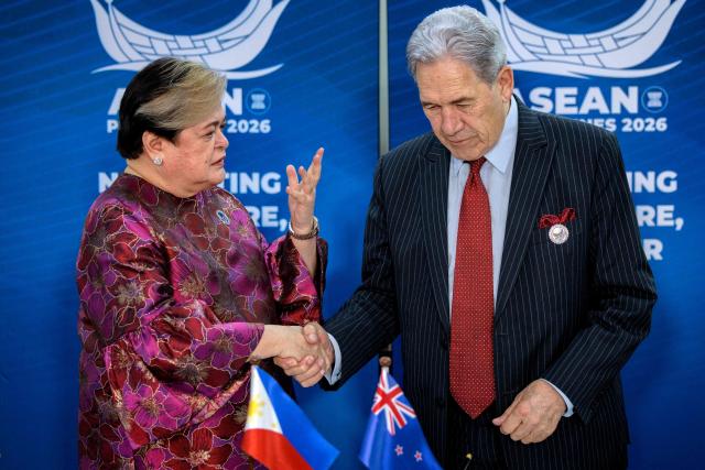 Philippines Foreign Secretary Theresa Lazaro (L) and New Zealand Foreign Minister Winston Peters shake hands during a bilateral meeting on the sidelines of the Association of Southeast Asian Nations (ASEAN) Foreign Ministers' Meeting in Pasay, Metro Manila on July 21, 2026. (Photo by Ezra Acayan / POOL / AFP)