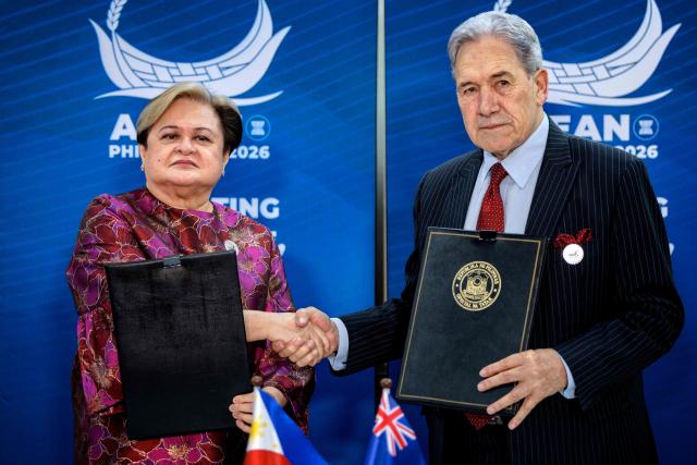 Philippines Foreign Secretary Theresa Lazaro (L) and New Zealand Foreign Minister Winston Peters shake hands during a bilateral meeting on the sidelines of the Association of Southeast Asian Nations (ASEAN) Foreign Ministers' Meeting in Pasay, Metro Manila on July 21, 2026. (Photo by Ezra Acayan / POOL / AFP)