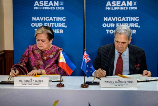 Philippines Foreign Secretary Theresa Lazaro (L) and New Zealand Foreign Minister Winston Peters sign an agreement during a bilateral meeting on the sidelines of the Association of Southeast Asian Nations (ASEAN) Foreign Ministers' Meeting in Pasay, Metro Manila on July 21, 2026. (Photo by Ezra Acayan / POOL / AFP)